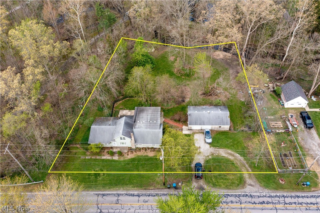 6066 Case Road North Ridgeville, OH 44039 - Photo 7 of 19 Expansive lot featuring a primary residence, detached garage structure, and mature surrounding trees