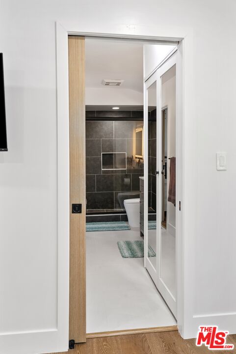 4118 Oak Hollow Road Calabasas, CA 91302 - Photo 44 of 55 a view of a hallway with wooden floor
