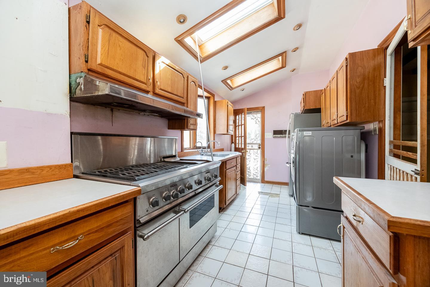 875 Old State Road Berwyn, PA 19312 - Photo 8 of 15 a kitchen with a stove cabinets and a refrigerator