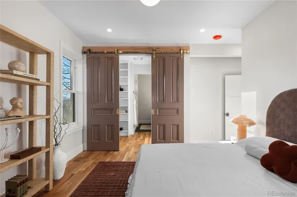 a bedroom with furniture and a book shelf