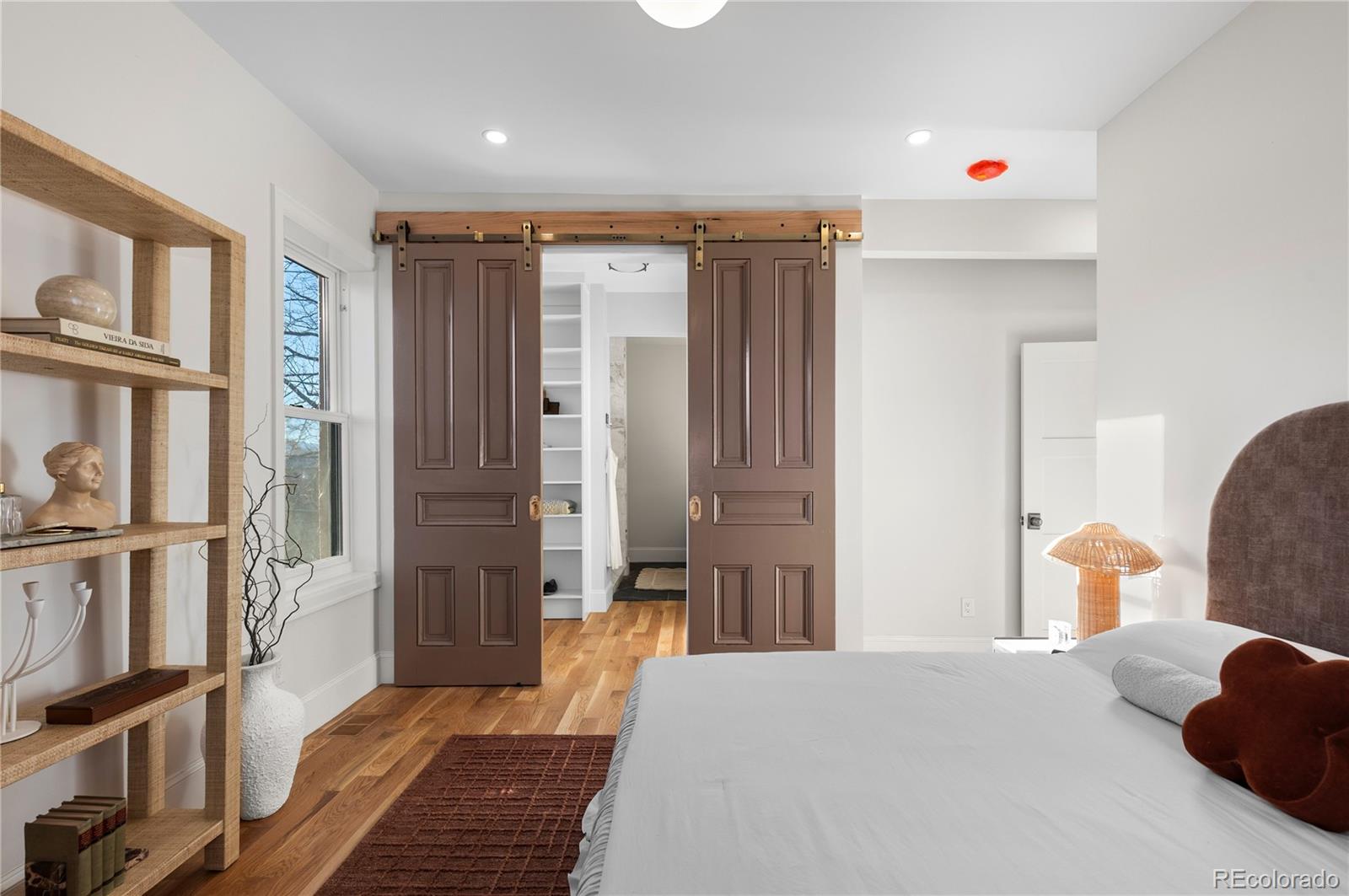 817 29th Street Denver, CO 80205 - Photo 11 of 33 a bedroom with furniture and a book shelf