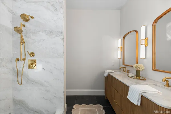a bathroom with a sink vanity mirror and shower