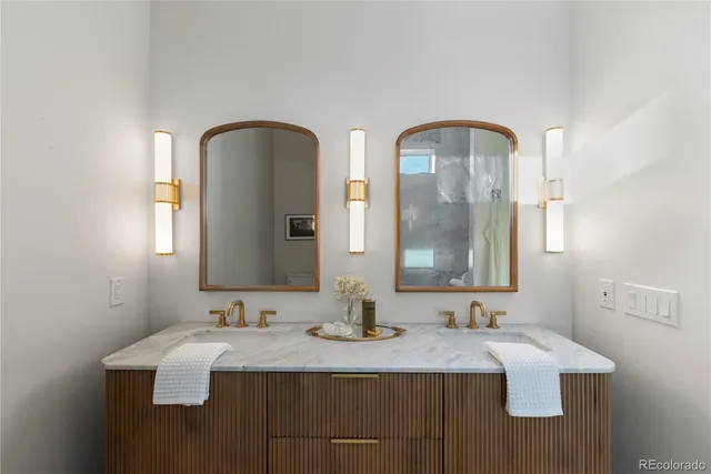 a bathroom with a double vanity sink and mirror