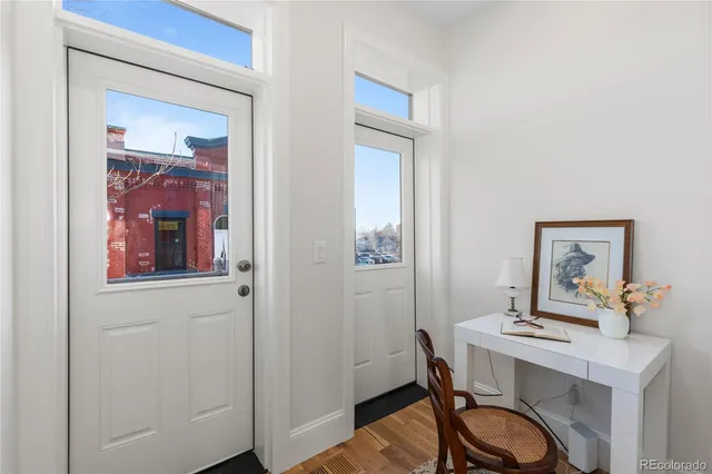 a view of a hallway with furniture