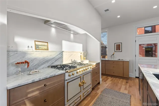 a kitchen with stainless steel appliances granite countertop a stove and a sink