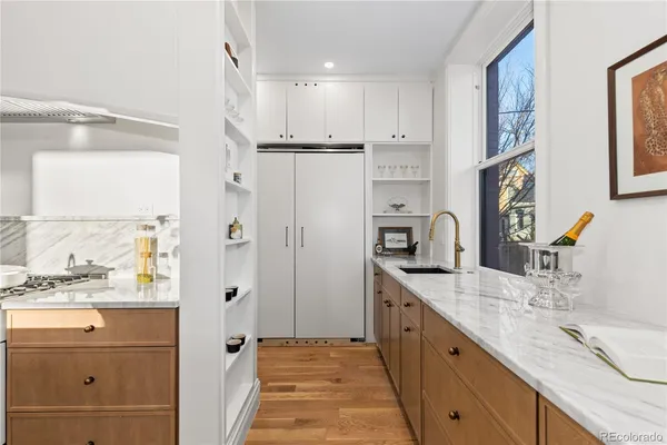 a bathroom with a granite countertop sink mirror and double