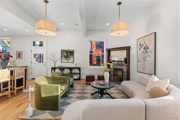 a living room with furniture a dining table and a chandelier