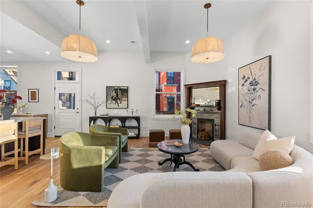 a living room with furniture a dining table and a chandelier