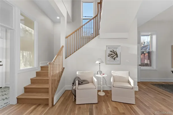 a living room with furniture and stairs