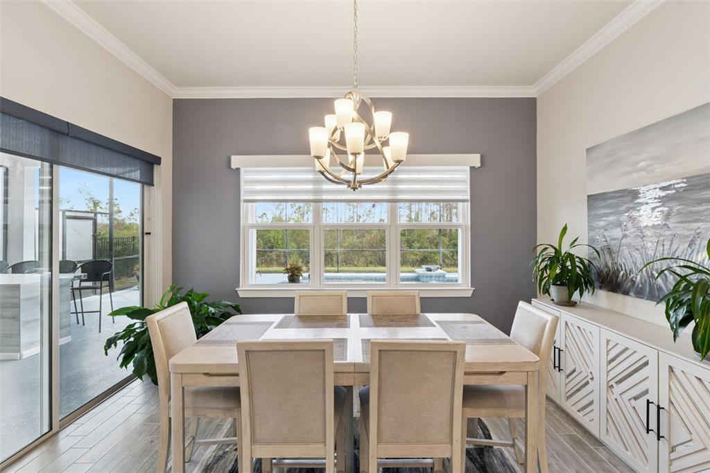 2745 Nature Vw Road St. Cloud, FL 34771 - Photo 13 of 50 a view of a dining room with furniture a chandelier and wooden floor