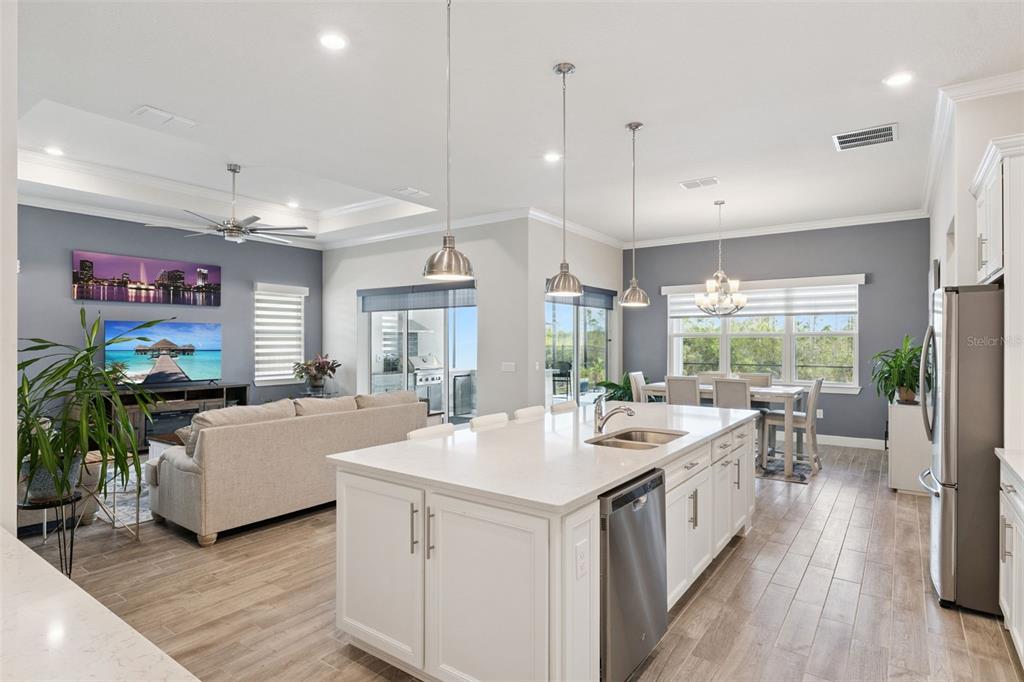 2745 Nature Vw Road St. Cloud, FL 34771 - Photo 2 of 50 a large white kitchen with a large window a sink dishwasher and a stove with wooden floor