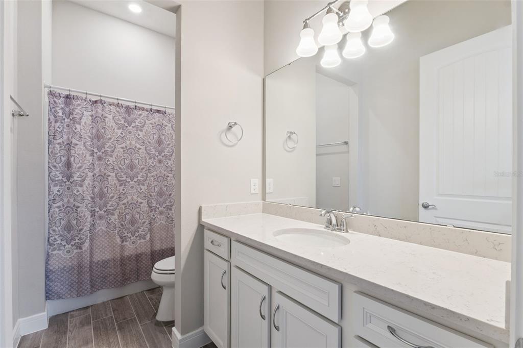 2745 Nature Vw Road St. Cloud, FL 34771 - Photo 24 of 50 a bathroom with a sink a toilet and shower