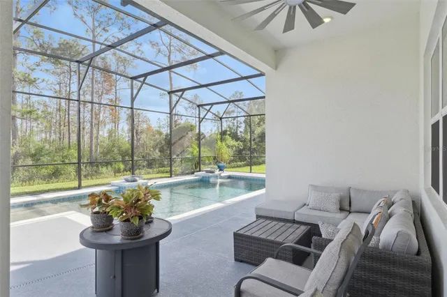 a living room with furniture and a floor to ceiling window