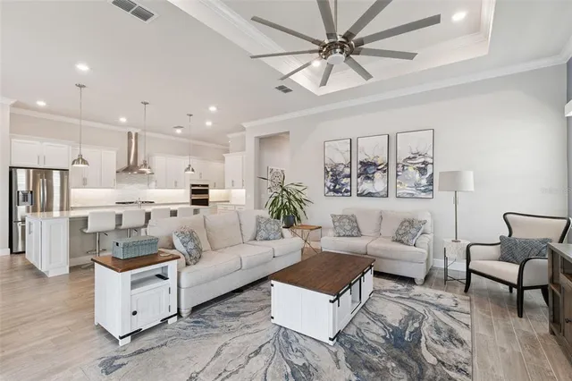 a living room with furniture and a view of kitchen