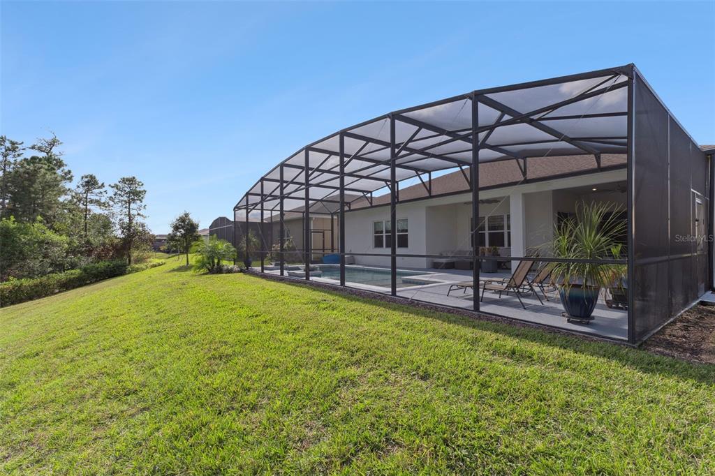 2745 Nature Vw Road St. Cloud, FL 34771 - Photo 32 of 50 a view of a backyard with plants and a patio
