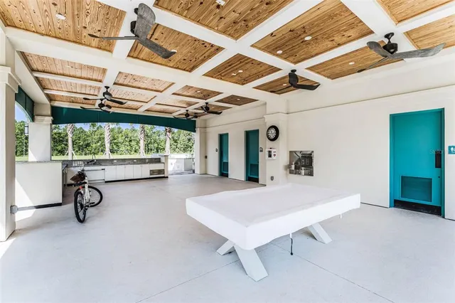 a view of a patio with a dining table and chairs with wooden fence