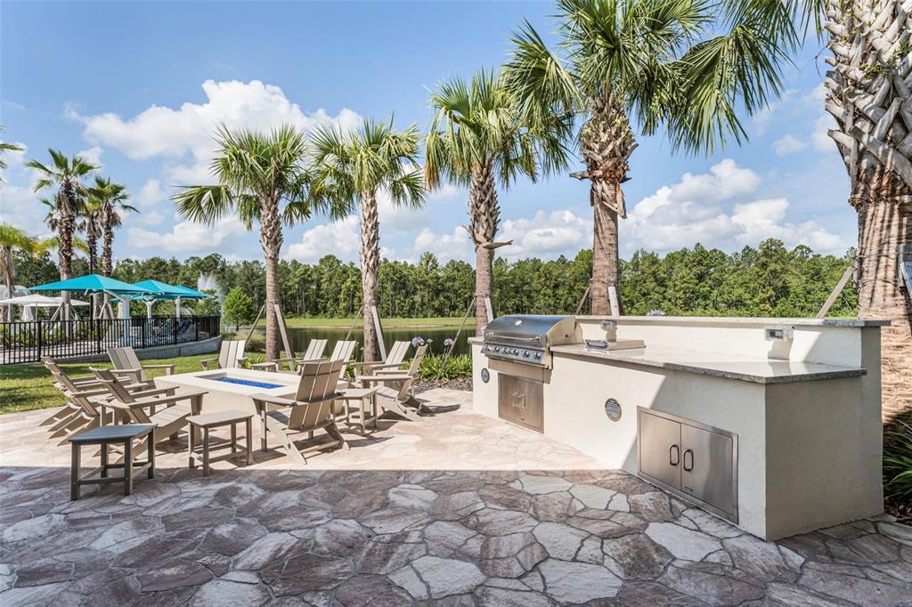 2745 Nature Vw Road St. Cloud, FL 34771 - Photo 44 of 50 a view of a patio with a dining table and chairs with wooden fence