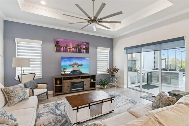 a living room with furniture a large window and a flat screen tv