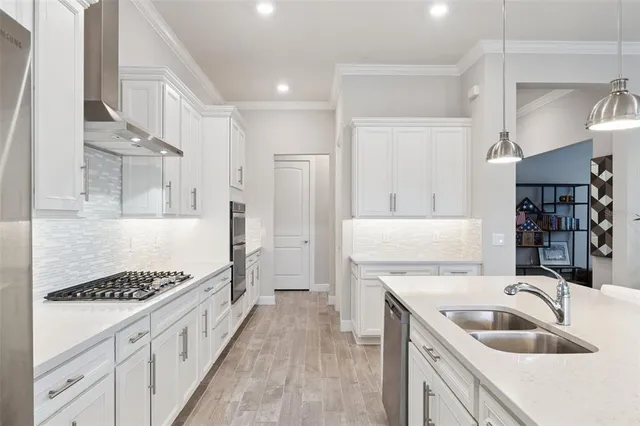 a kitchen with sink cabinets and stove