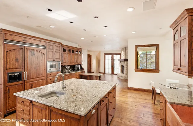 a large kitchen with kitchen island a sink counter space and stainless steel appliances