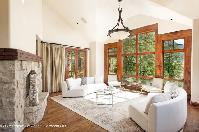 a living room with furniture and large windows