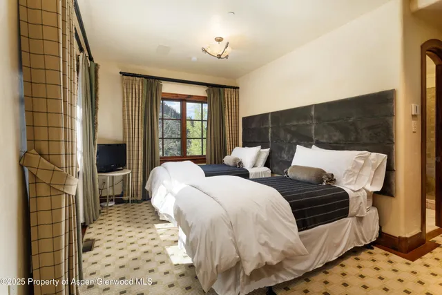 a bathroom with a tub a sink and a window