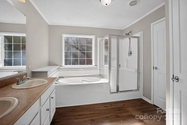 a bathroom with a granite countertop sink and a bathtub