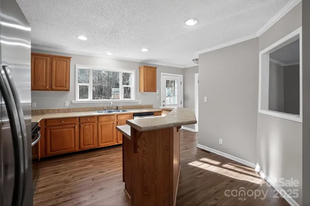 a kitchen with a sink cabinets and wooden floor