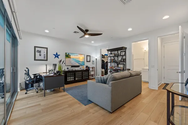 a living room with furniture and a wooden floor