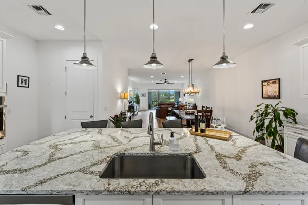 a view of a kitchen with kitchen island a sink and living room view