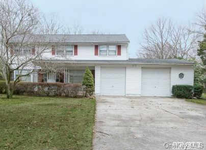 67 Half Hollow Road Commack, NY 11725 - Photo 1 of 1 a front view of a house with a garden