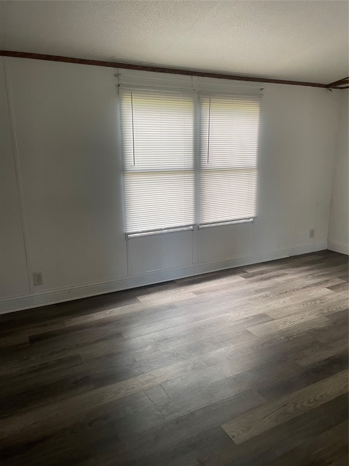 18759 Fire Fly Drive Porter, TX 77365 - Photo 11 of 11 an empty room with wooden floor and windows with curtains
