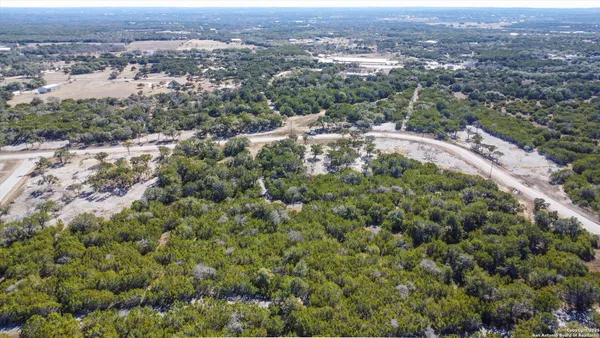an aerial view of residential house with green space