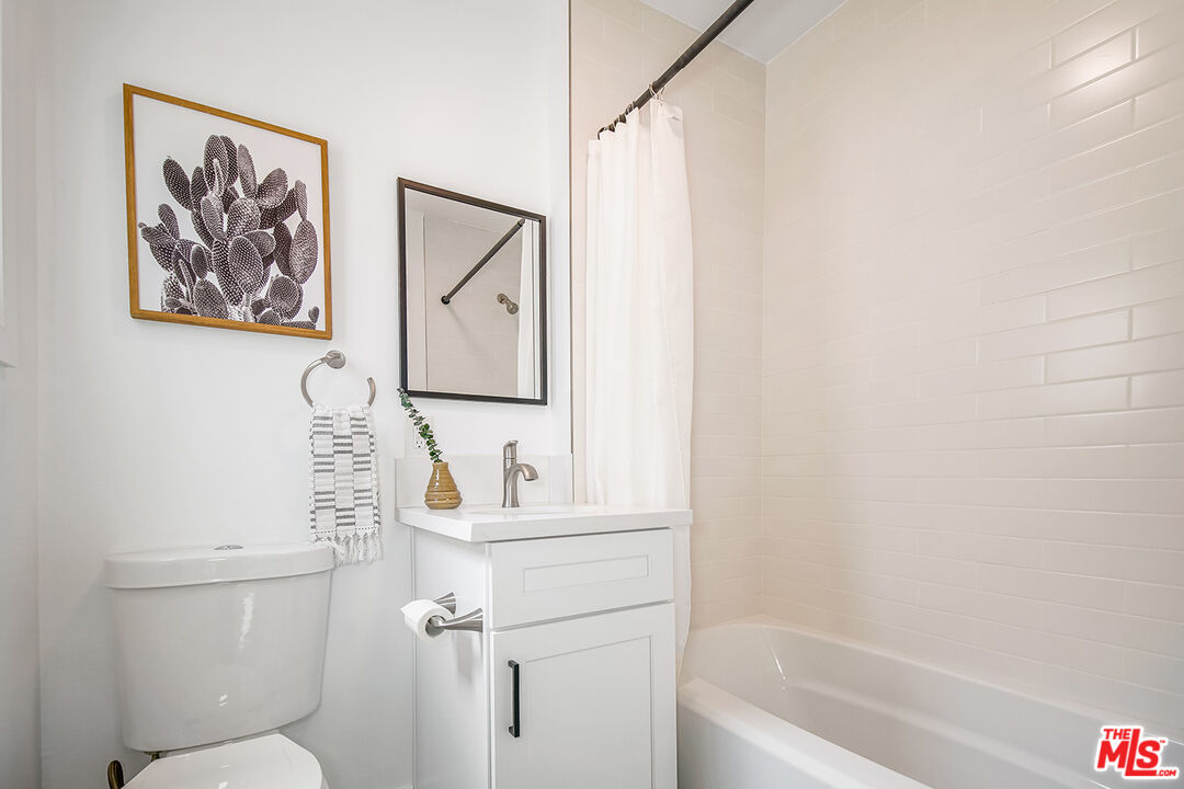 1217 9th Street, Unit 9 Santa Monica, CA 90401 - Photo 11 of 14 a bathroom with a toilet a sink and a bathtub