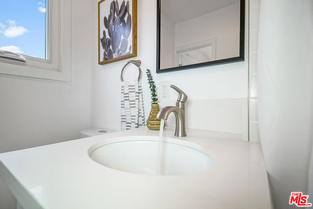 1217 9th Street, Unit 9 Santa Monica, CA 90401 - Photo 12 of 14 a bathroom with a sink and a mirror