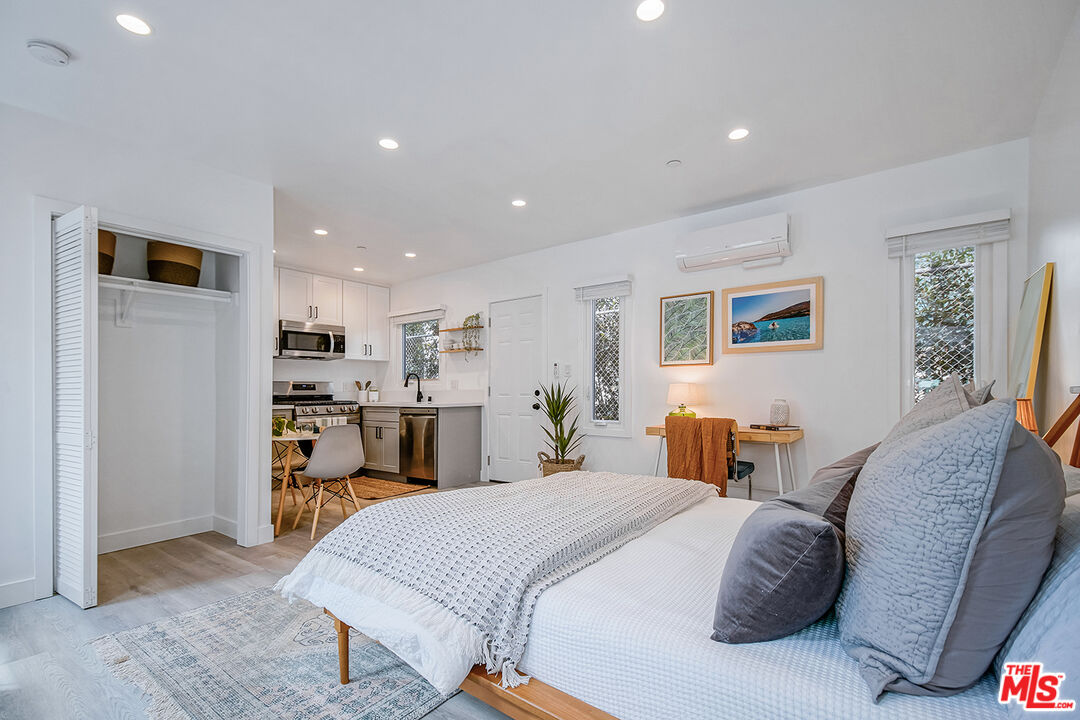 1217 9th Street, Unit 9 Santa Monica, CA 90401 - Photo 6 of 14 a spacious bedroom with a bed and a view of kitchen