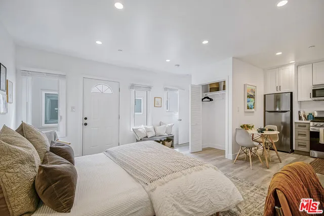 a bedroom with furniture and a closet