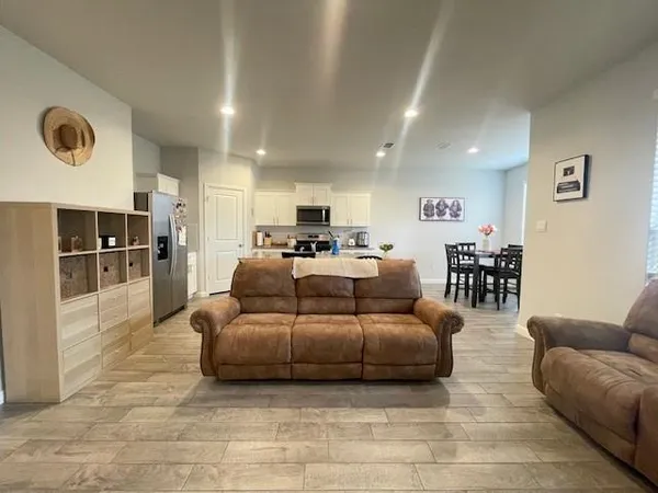 a large kitchen with granite countertop a large counter top stainless steel appliances and cabinets