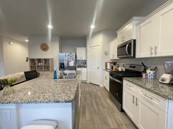 a kitchen with a sink stove and refrigerator