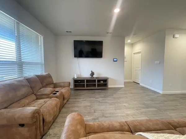 a bedroom with a bed and flat screen tv