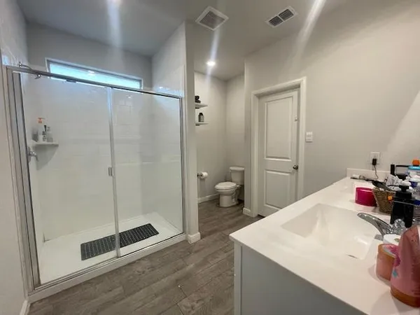 a bathroom with a shower and a toilet