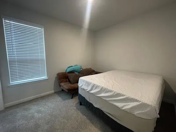 a bedroom with a bed and window