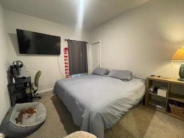 a bed room with furniture and a flat screen tv