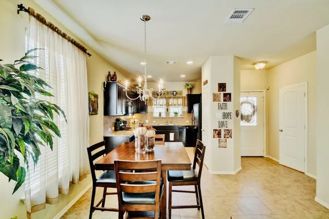 a dining room with furniture and chandelier