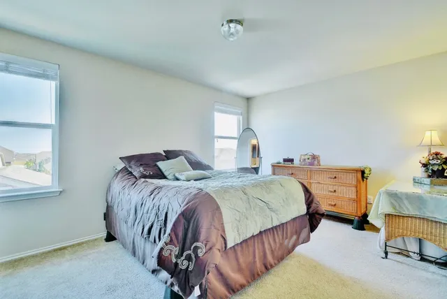 a spacious bedroom with a bed and window