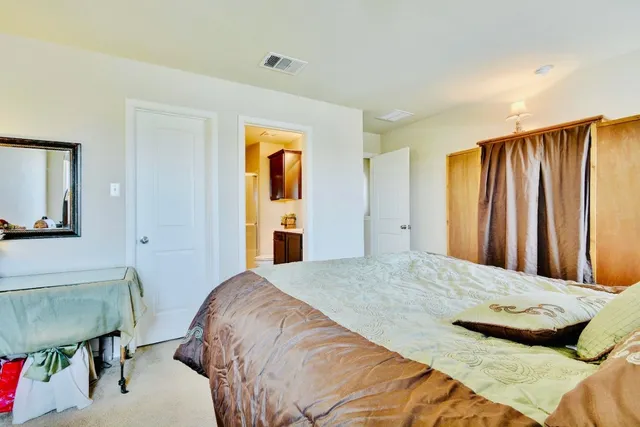 a bedroom with a bed and a chair