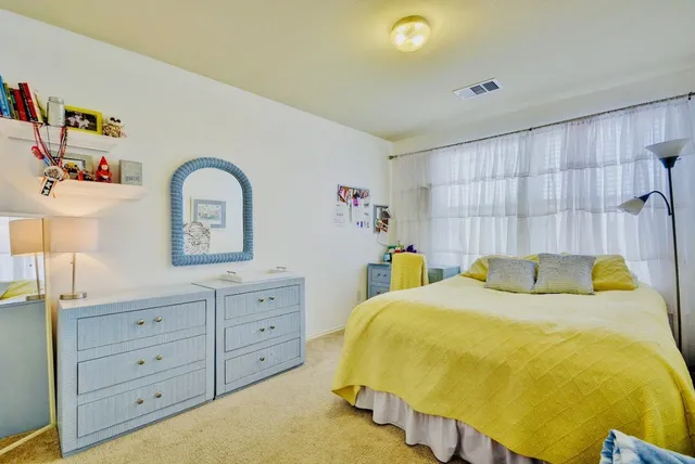 a bed room with a bed and a dresser