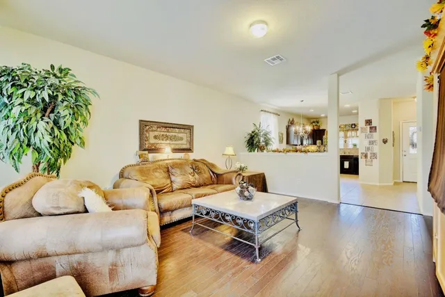 a living room with furniture and a wooden floor
