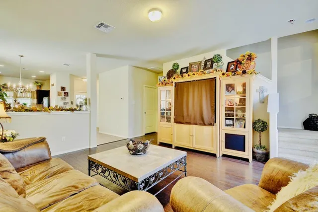 a living room with furniture and wooden floor