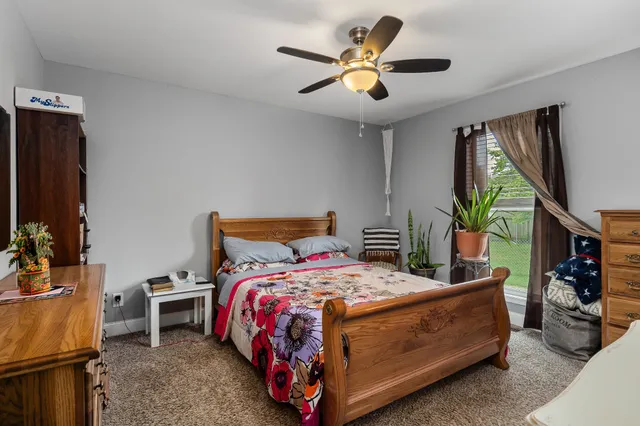 a bedroom with a bed and a chandelier